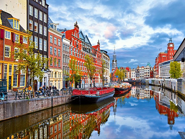 buildings by canal in amsterdam
